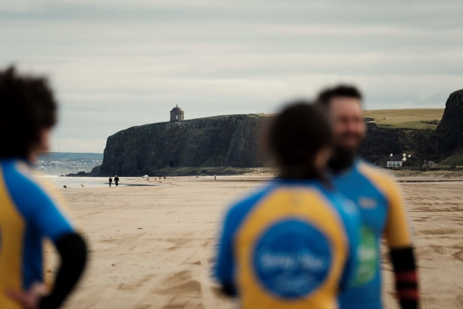 Friends learning to surf together at Long Line Surf School, Limavady